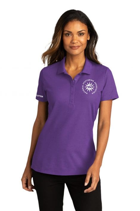 A woman wearing a purple polo shirt with a logo on the left chest and "NSA Golf Towel" text on the right sleeve stands facing the camera, smiling subtly.