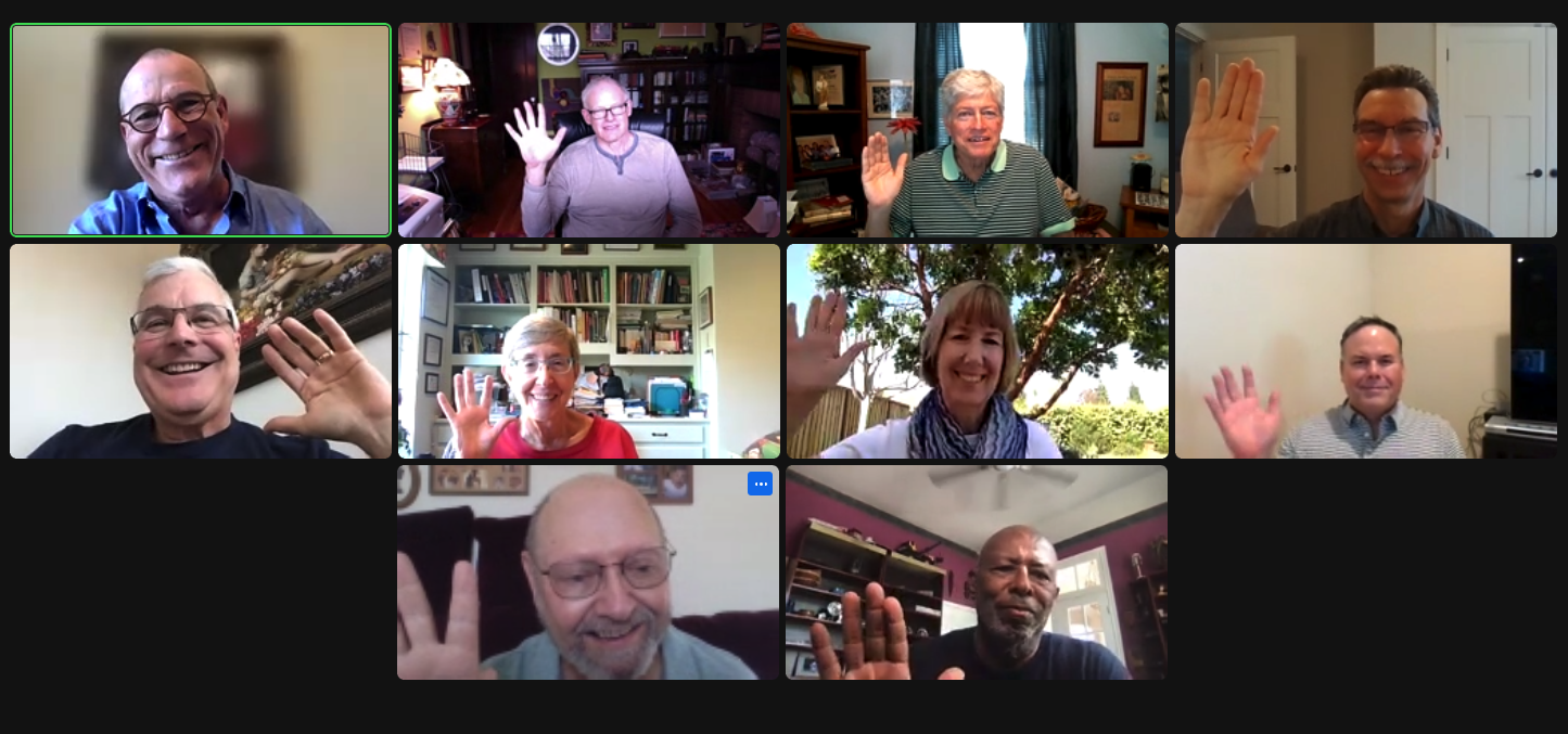 Nine people in a virtual meeting, each in different settings, smiling and waving at the camera in their individual video frames.