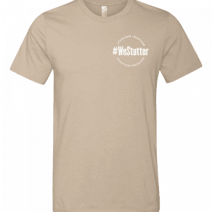 #WeStutter Adult Tee in beige, showcasing a small white circular logo on the upper left side with the hashtag "#WeStutter" and the words "Support," "Inspire," and "Together" encircling it.